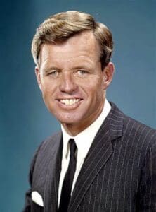 A man in a suit and tie smiling for the camera.